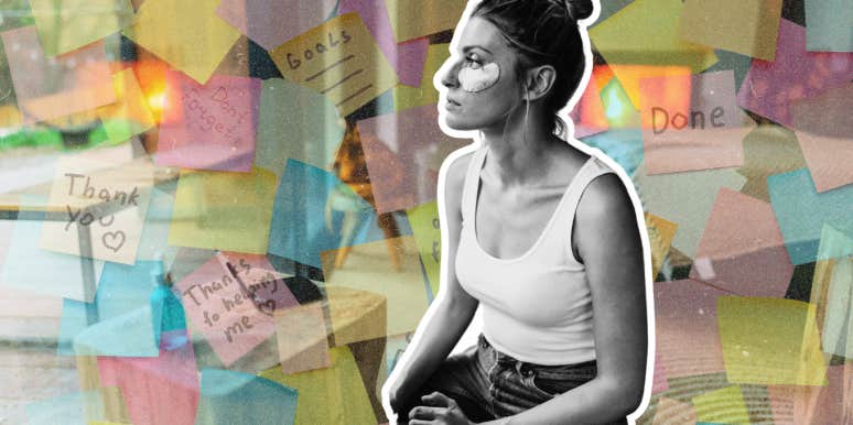 woman practicing self care in front of a vision board 