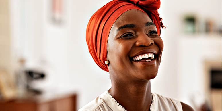 how to be who you are as you age Lovely Black woman in orange hair wrap, smiling joyfully