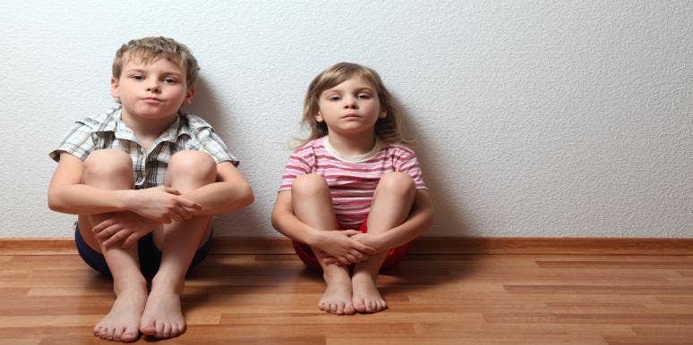 little boy and little girl sitting on floor