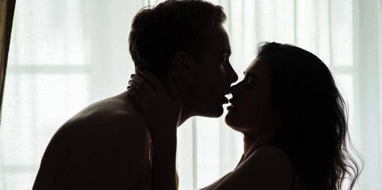 Man Charged With Rape After Removing Condom During Consensual Sex man kissing woman in shadow