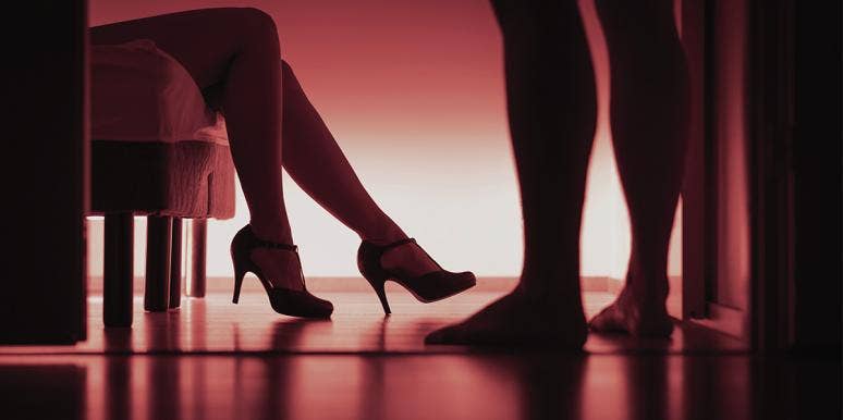 I'm A Sex Worker — But I Never Actually Sleep With My Clients high heels with red lighting background