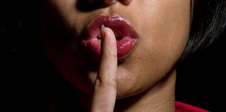 woman saying shhh