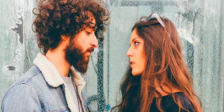 Should Your Partner Stand Up For You, Even If You're Wrong? man and woman staring at each other fighting upset