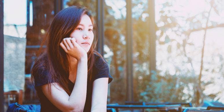 shut off feelings sad woman looking out the window