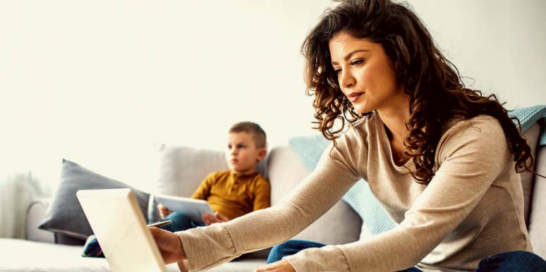 Side hustle Woman working at home with child in background