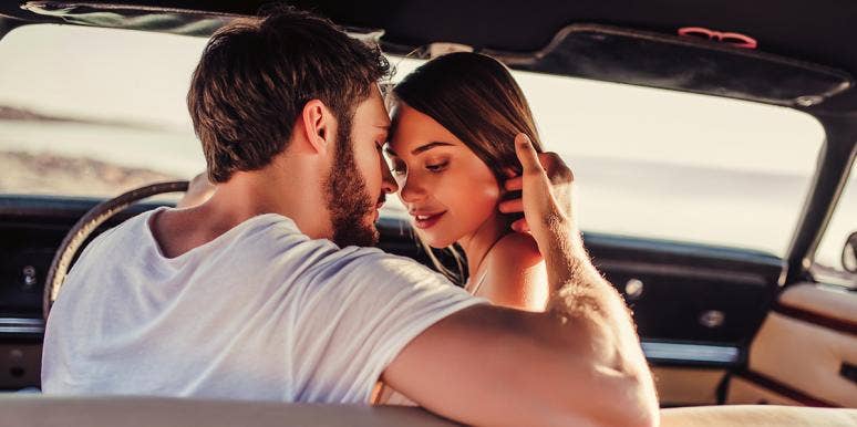 man and woman about to kiss in a car