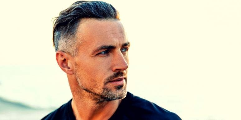 10 signs of a good man handsome man with chiseled features, slightly greying in his hair and goatee, looks over his shoulder