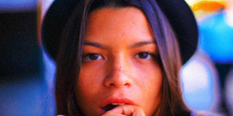 7 Signs You're A Man-Eater woman who may be a man-eater looking at the camera