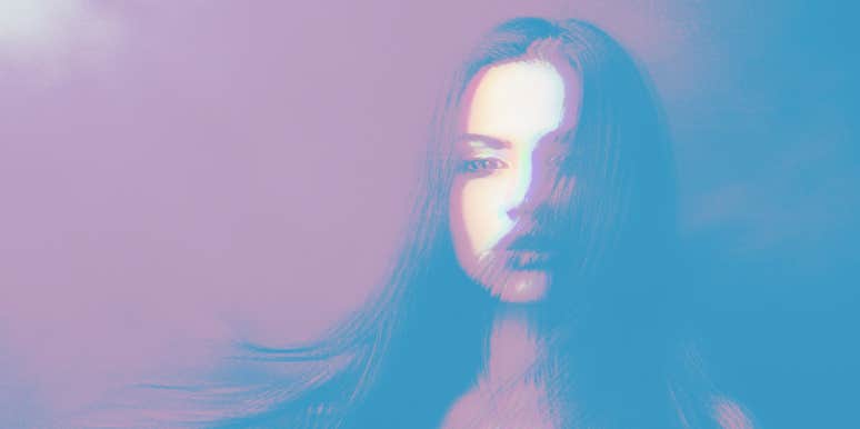 15 Spiritual & Psychic Signs Someone Is Thinking About You woman with hair covering part of her face