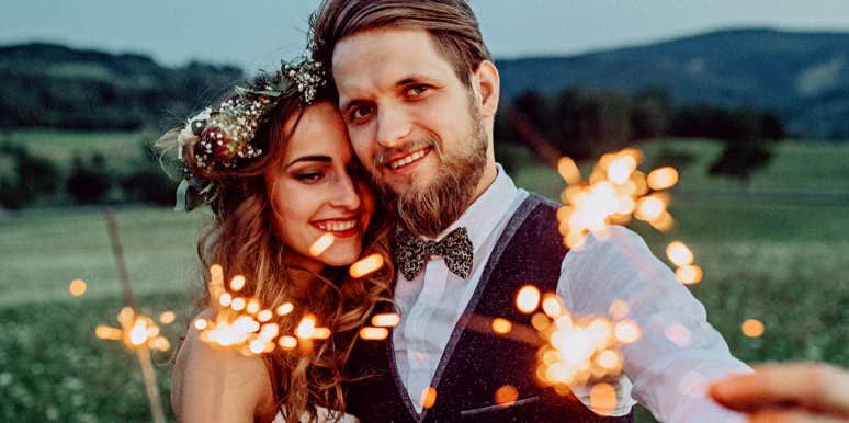 10 Subtle Signs The Universe Wants You To Be With Someone man and woman with sparklers