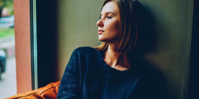 woman looking out a window