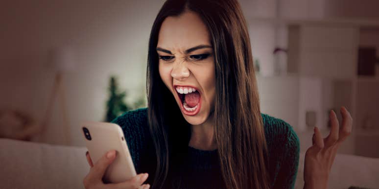 angry woman looking at phone
