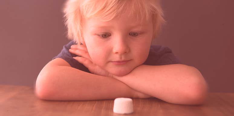 boy looking at a marshmallow