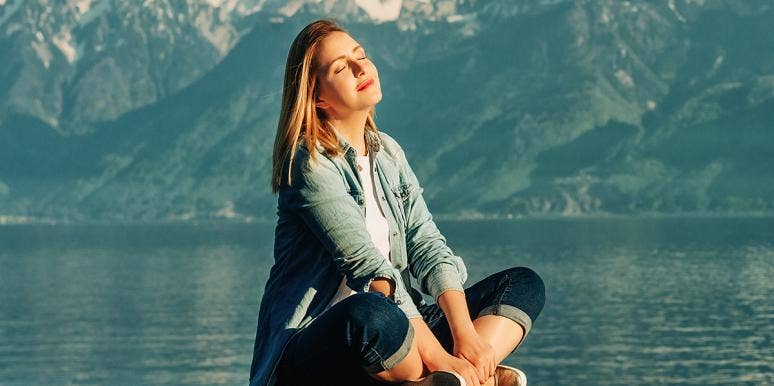 woman meditating on a lake