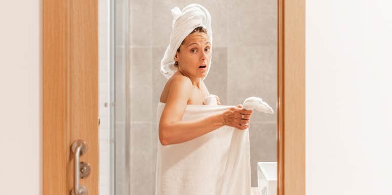 Woman caught naked in towel in bathroom 