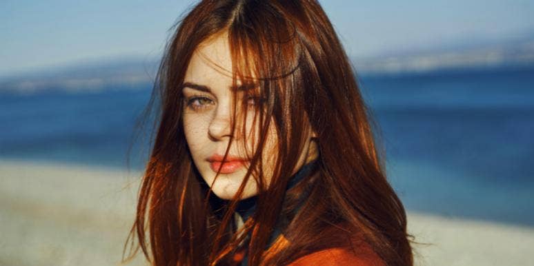 6 Smartest Zodiac Signs That Are Extremely Intelligent Geniuses redheaded woman at the beach
