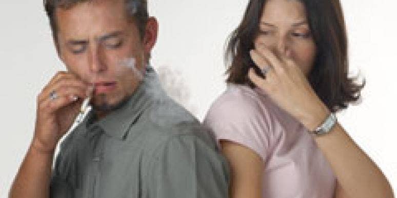 Nobody Wants To Date A Smoker woman choking on man's cigarette smoke