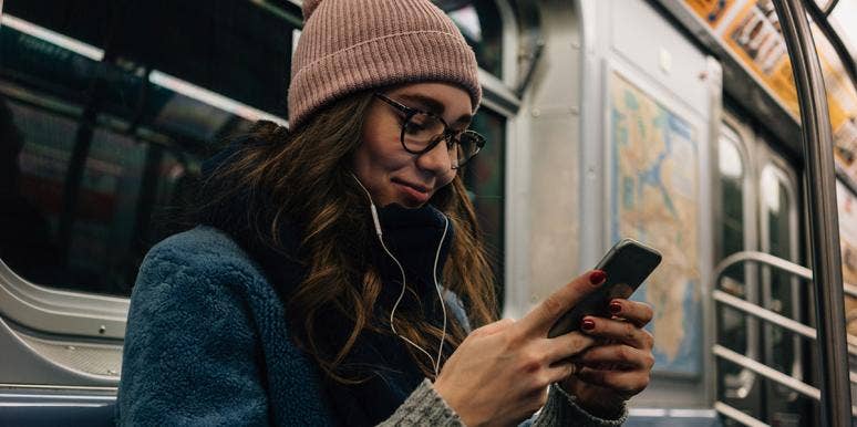 How Social Media Fueled An Out-Of-Control Obsession With My Ex waoman texting on subway