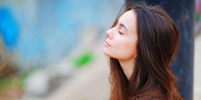 The Solar Plexus Chakra & Claiming Your Personal Power woman meditating outside with her eyes closed