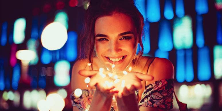 How An Astrology Reading Saved Me From A Toxic Relationship woman holding lights