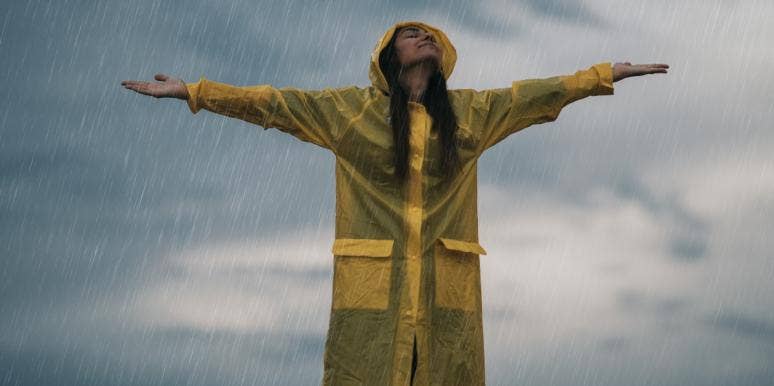 woman in raincoat standing in the rain