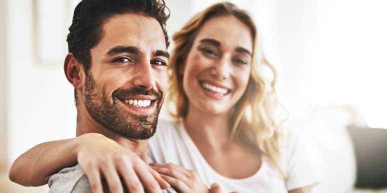 6 Unsexy Ways To Tell If You’re Soulmates — Or Just Roomates woman and man smiling at camera