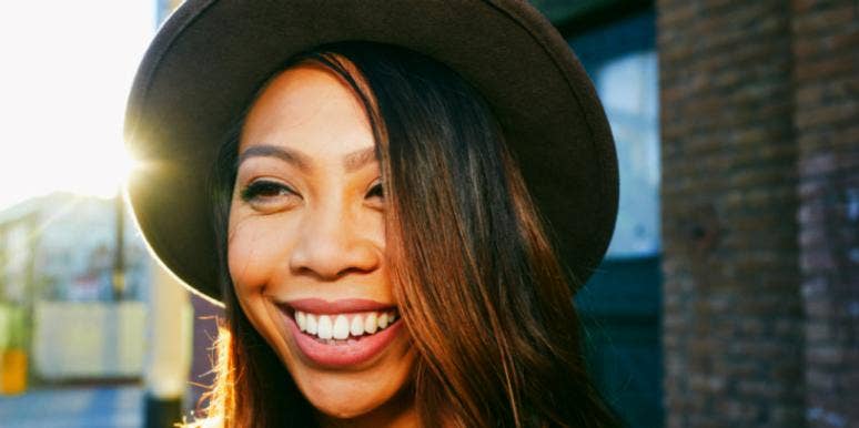 Signs Of Spiritual Connection & How To Grow With Your Partner woman in wide brimmed hat smiling