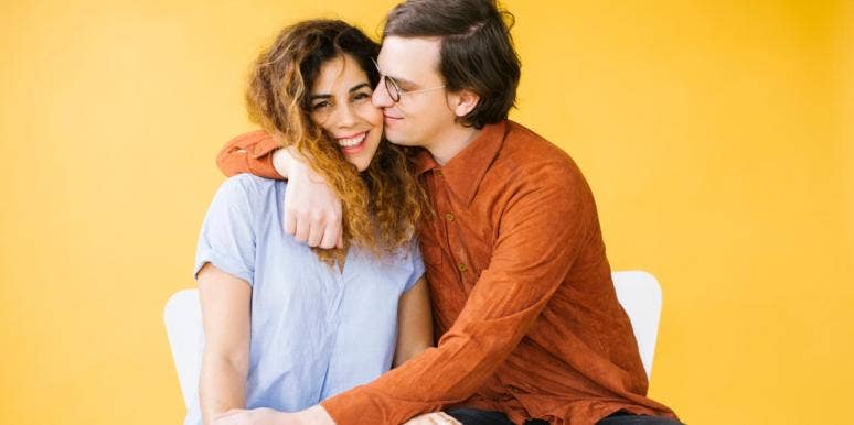 stages of love couple cuddling in front of yellow background