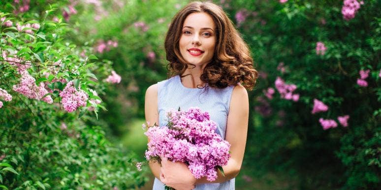 happy woman holding flowers