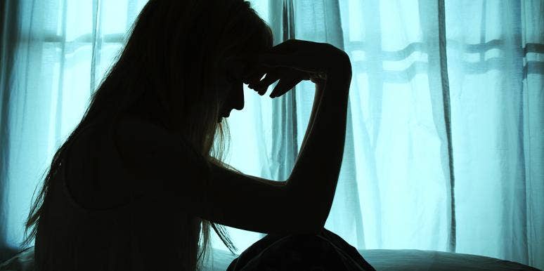 How My First Sexual Partner Almost Became My Last woman in shadow with hands on forehead