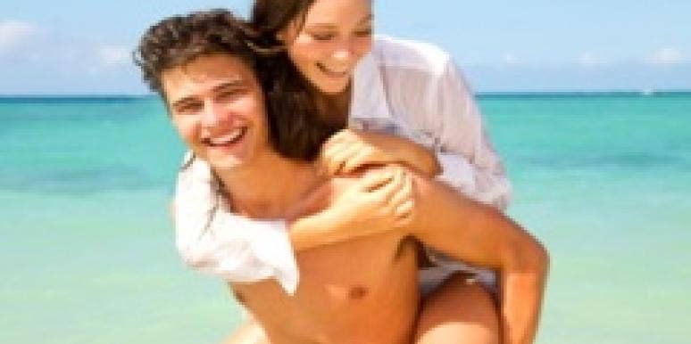 3 Ways Hot Weather Leads To Good Sex couple on the beach piggy back