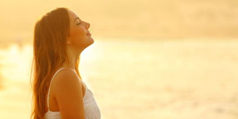 What Is A Sun Sign? Meaning & How To Find Your Zodiac Sign woman standing in sunlight