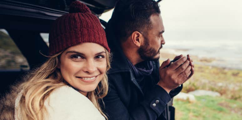 couple in the back of a car, woman smiles at camera