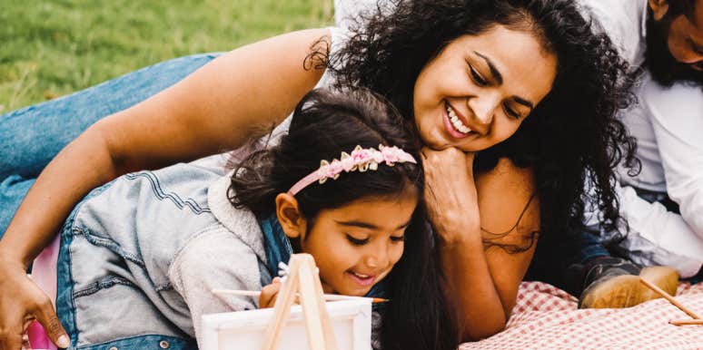 how to talk to kids about bad grades without shame mom and daughter look at her art on picnic blanket
