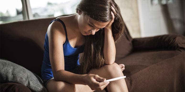 Teenage Pregnancy, Fake Champagne, and Never Regretting My Fucking Kids girl holding pregnancy test
