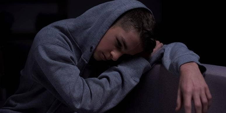 The Devastating Reality Of Raising A Teenage Addict moody photo of teenager in hoody