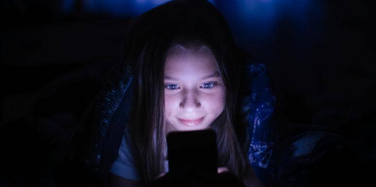 woman in dark on computer