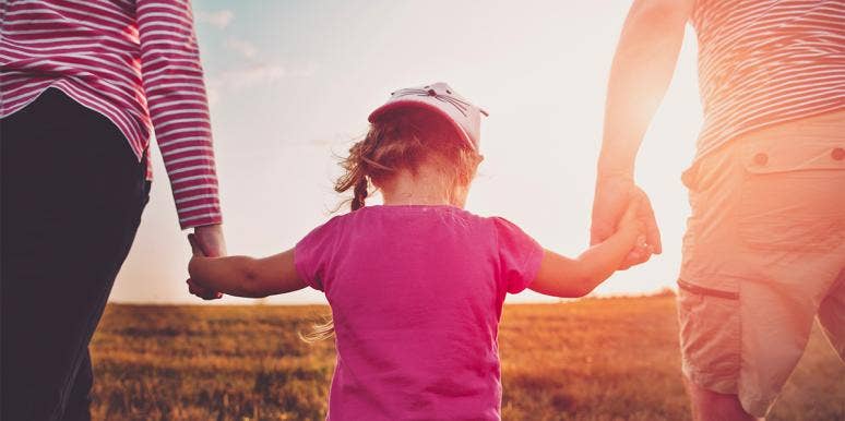 Yes, Tell Your Kids You Regret Having Them parents holding hands with daughter