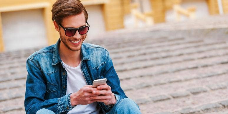 18 Texts Men Send Women — And What They Really Mean man in suit jacket texting on phone