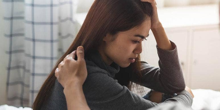8 Brutally Honest Marriage Truths I Learned From My Therapist woman with head in hands looking pained