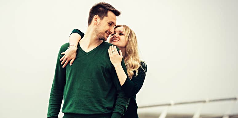 Things a good wife won't do couple hugging on the ship of a deck, man in a vibrant green sweater