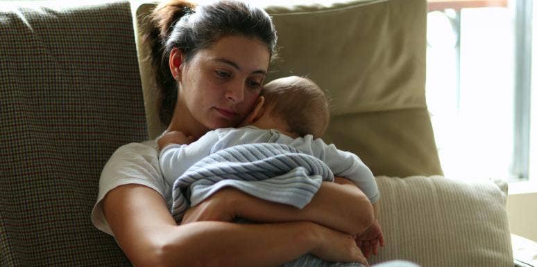 I Am Tired Of Being A Woman And Mother In The United States Of America exhausted mother holding baby