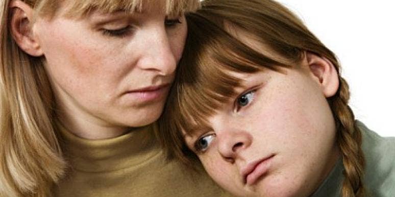 sad daughter leaning on mother's shoulder sad daughter leaning on mother's shoulder