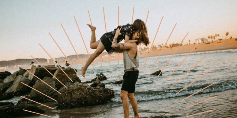 Couple on the beach together, man swinging woman in the air