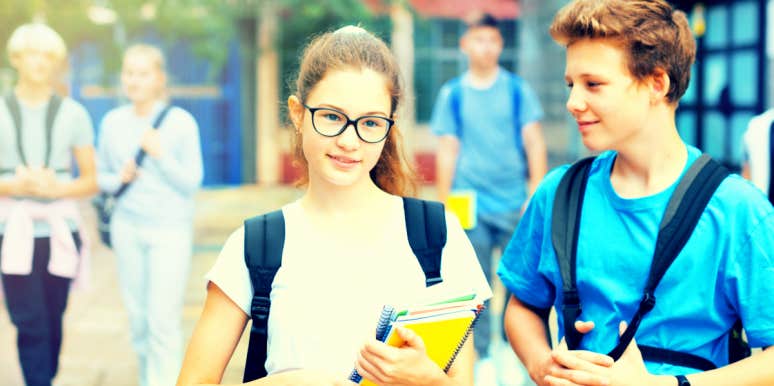 two kids, age 12, walk through school, boy clearly likes the girl