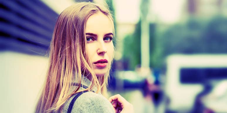 types of gaslighting in relationships woman looking over her shoulder, nervously