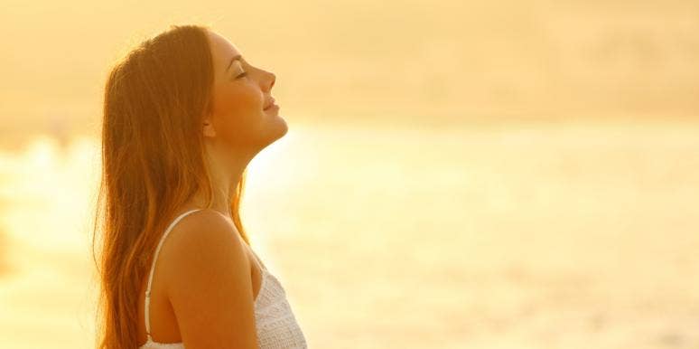 Understanding Your Sacral Chakra: A Complete Guide woman meditating at sunrise