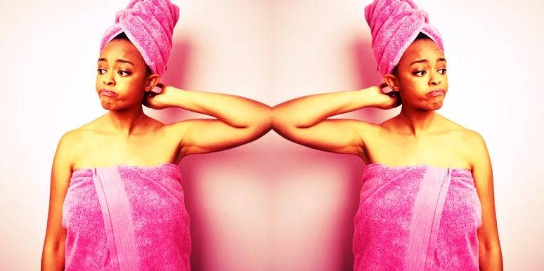 Why Your Vagina Smells Like Bleach Or Ammonia & What To Do About It woman in towel wondering why her vagina smells like bleach