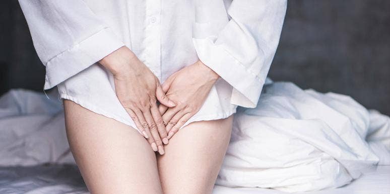 Why Your Vagina Smells Like Onions And What To Do About It woman in white shirt hands over legs