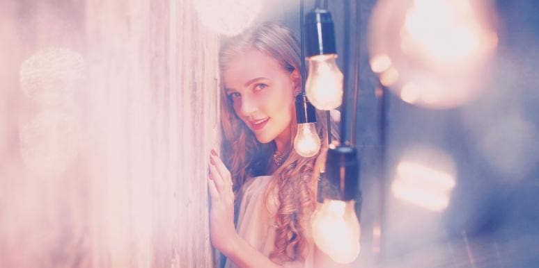 woman surrounded by lightbulbs